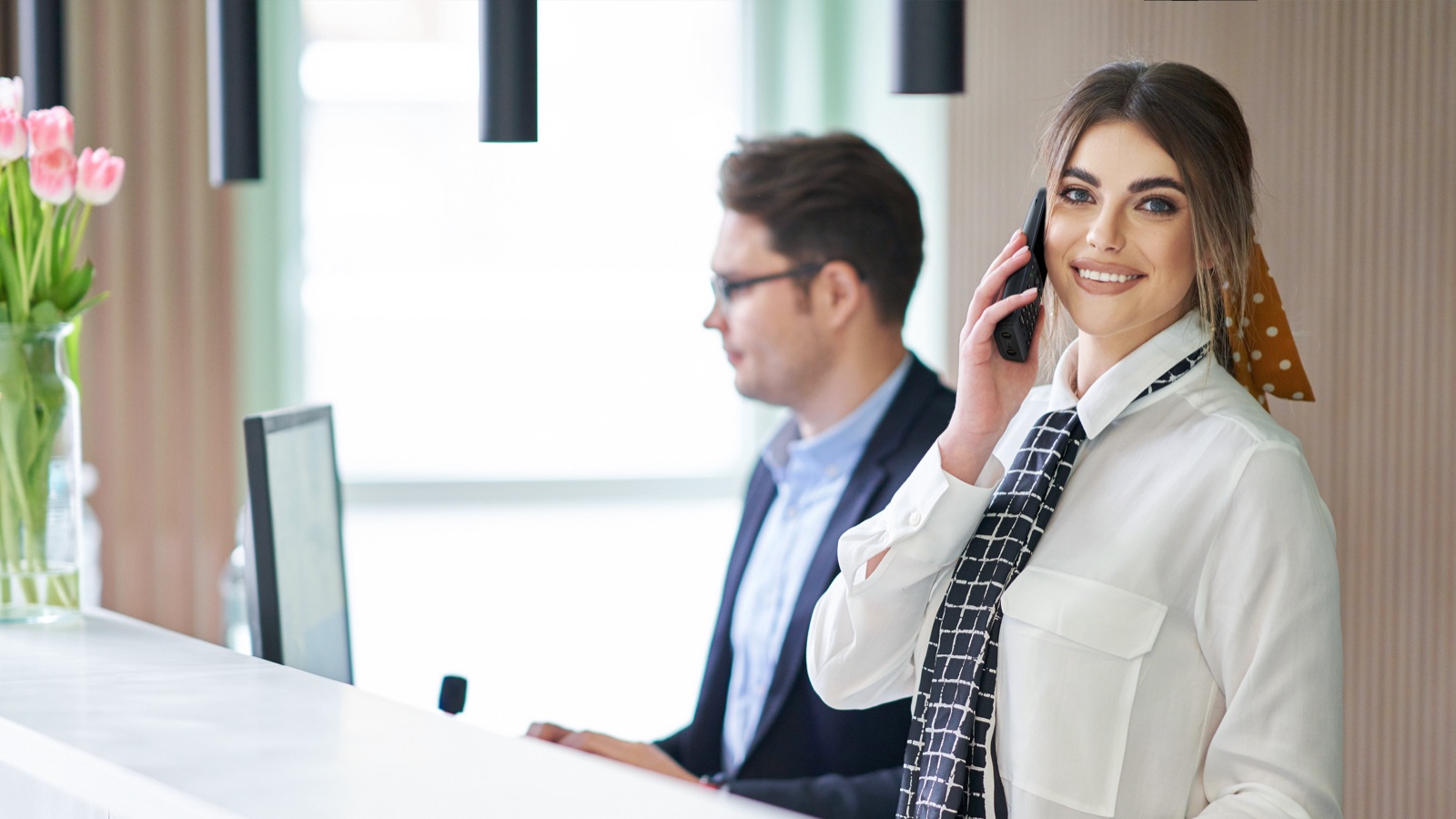 Yealink AX83H in a front-desk setting